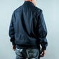 Man wearing a navy sports jacket from behind