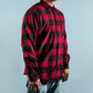 Man wearing chequered red and black shirt