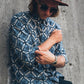 Man wearing a patterned ocean blue collared shirt